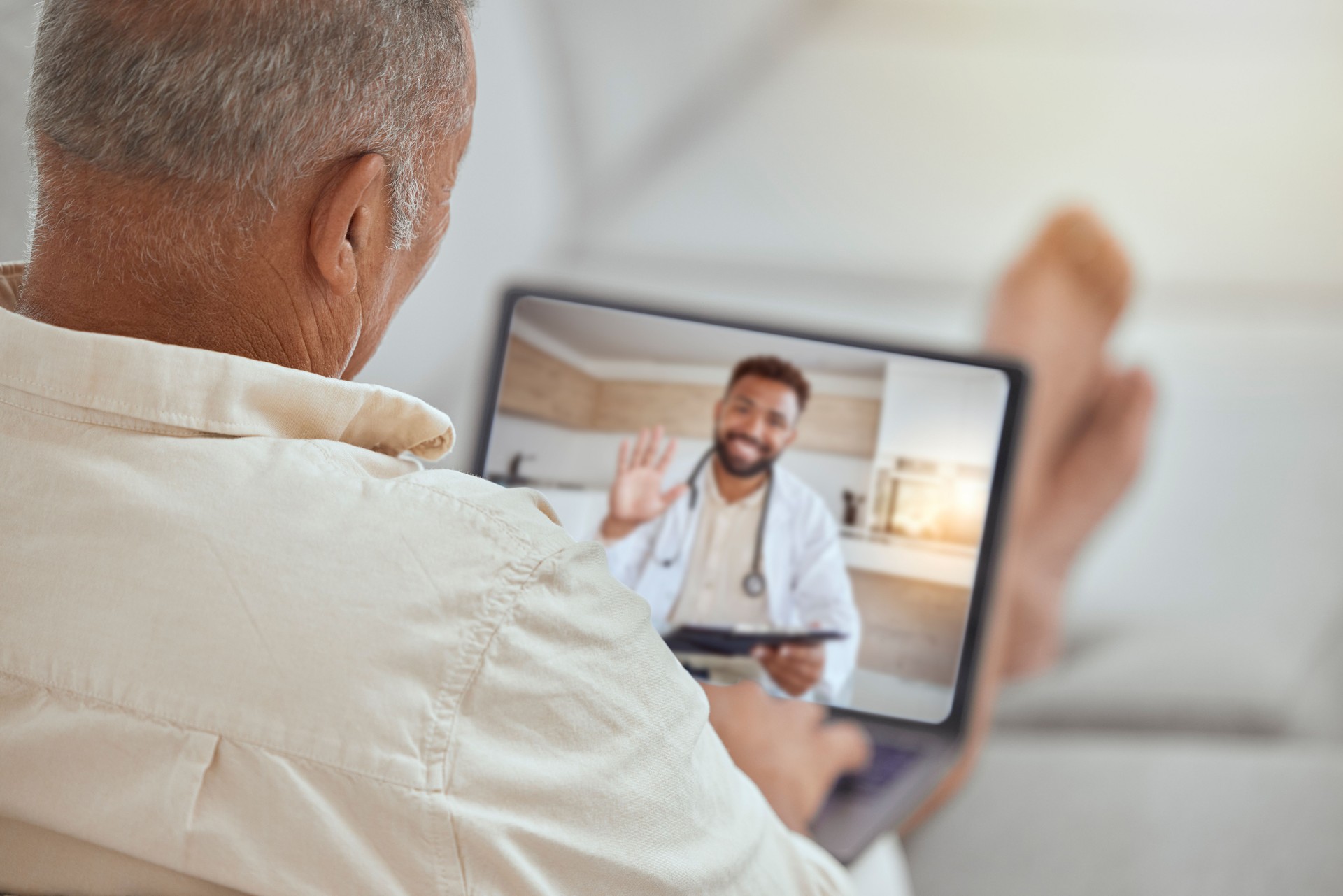 Laptop, healthcare and video call with a patient and doctor in an online medical assessment or remote consultation. Computer, internet and home consulting with a man talking to a health professional