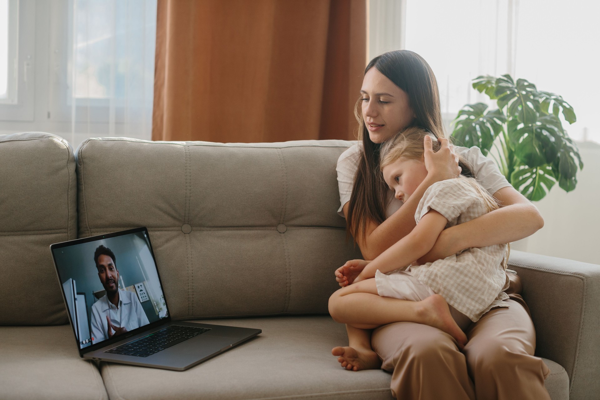 Consultation with a pediatrician online. A young mother with a sick child makes a video call to her doctor.